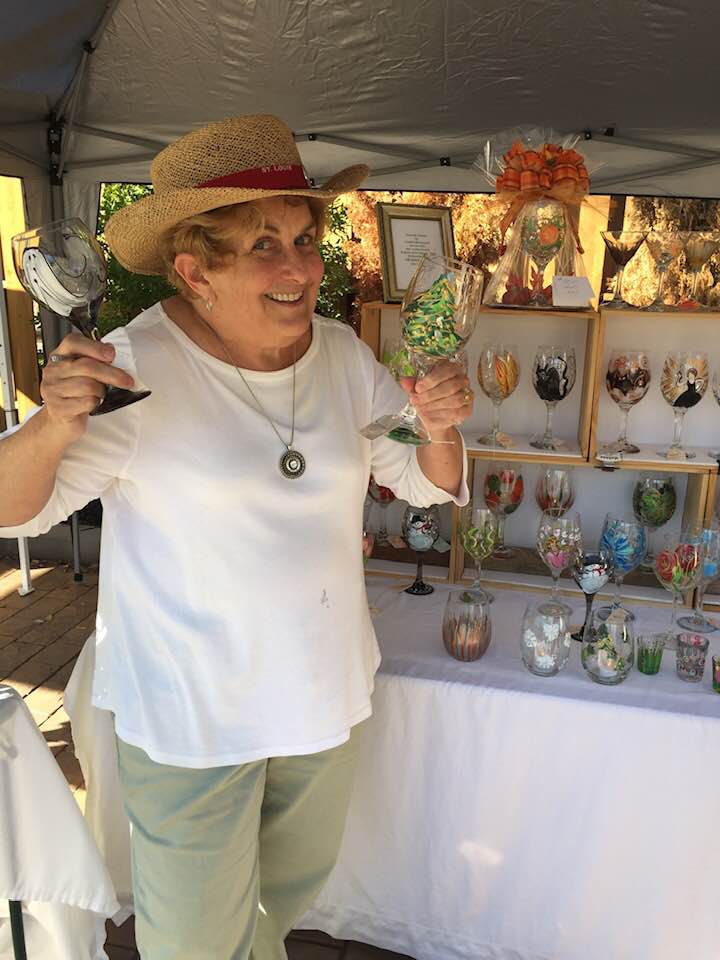 Connie at a local art fair selling hand-painted wine glasses.